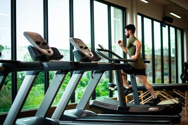 a man on a treadmill in a gym